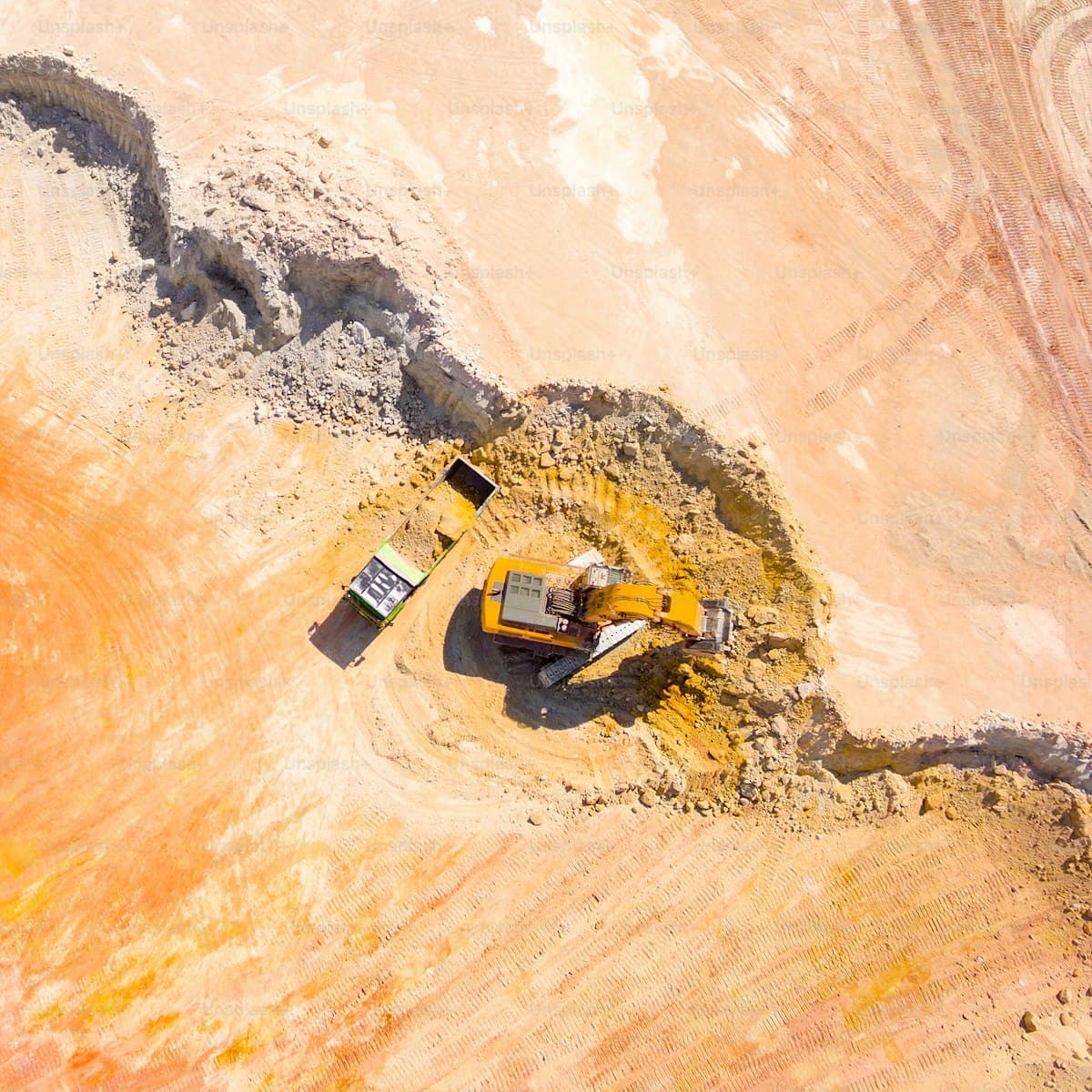 Aerial view of an excavator loading a truck